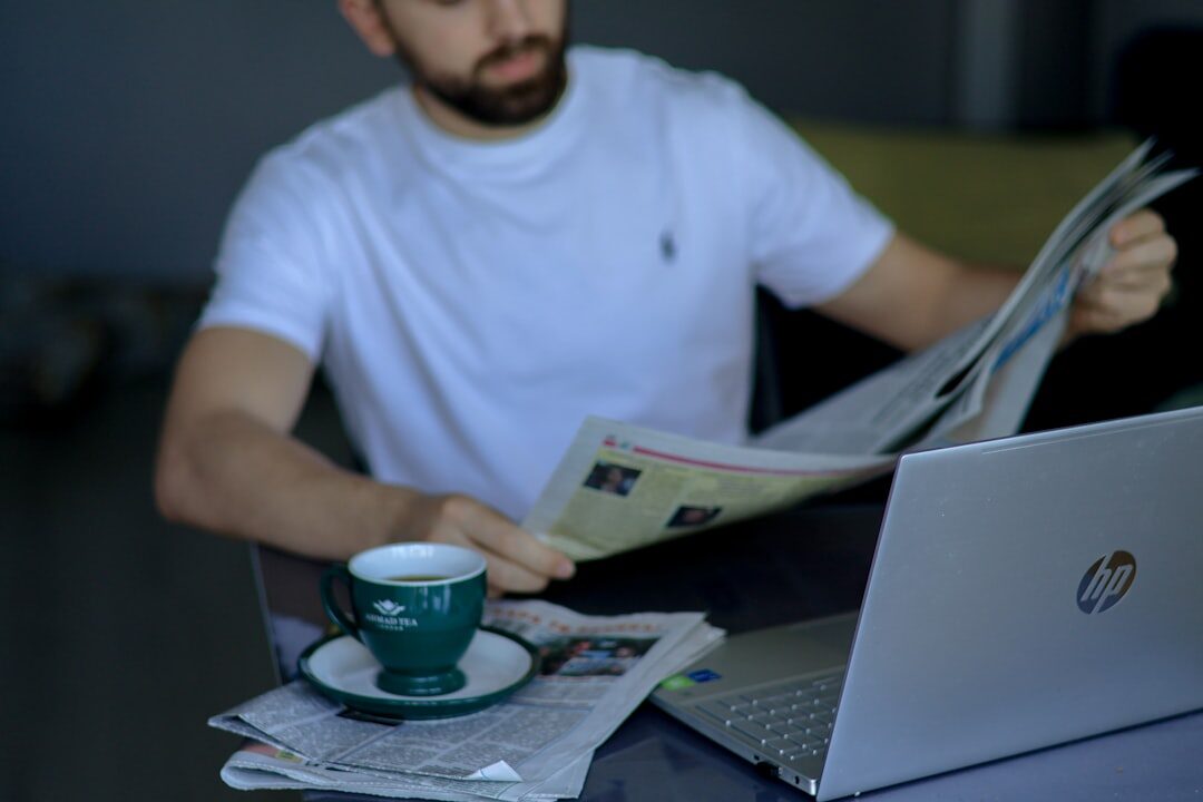 Person reading news on laptop